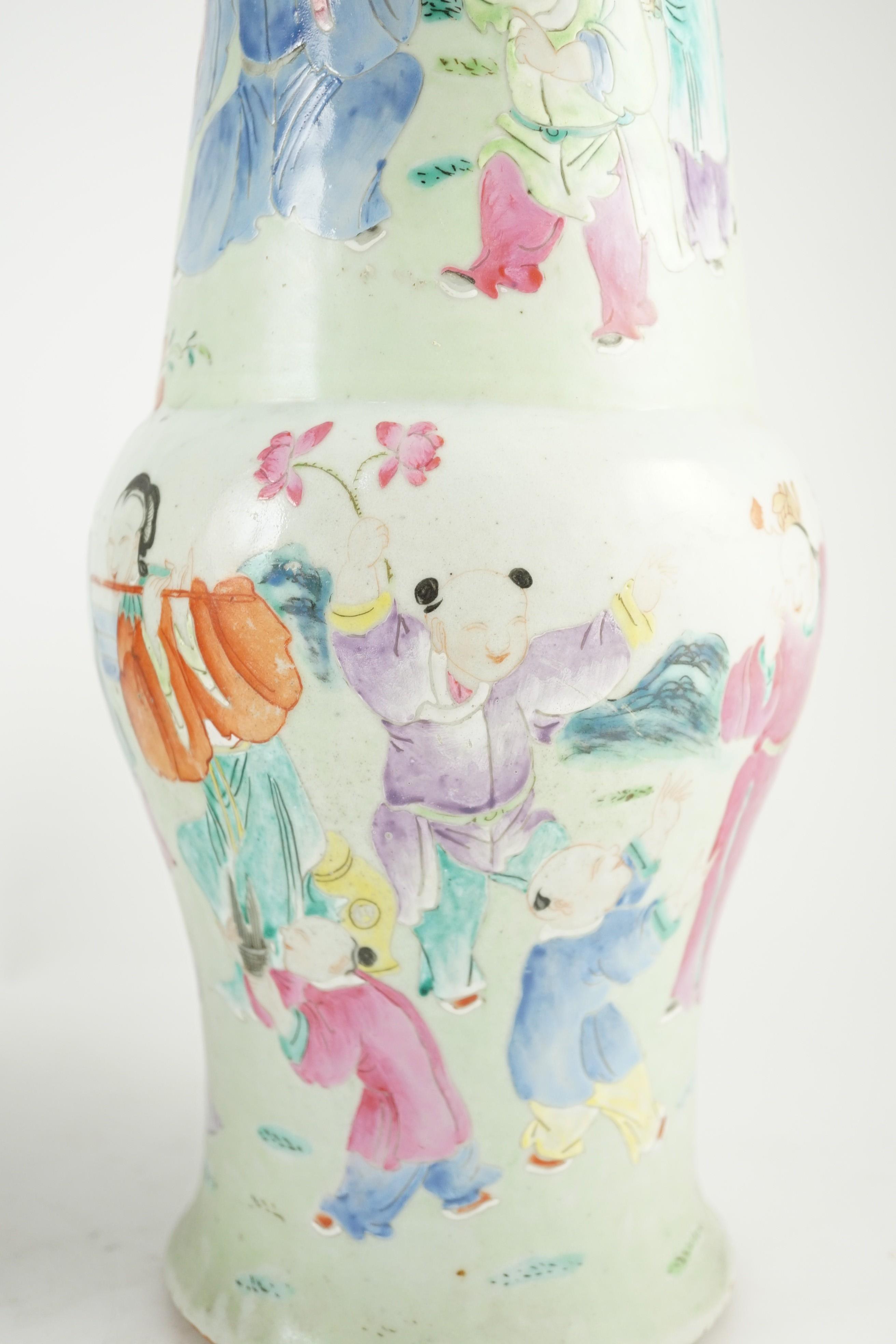 A pair of Chinese famille rose fencai ‘boys’ baluster vases, 19th century, 39.7 and 40cm high, hairline cracks